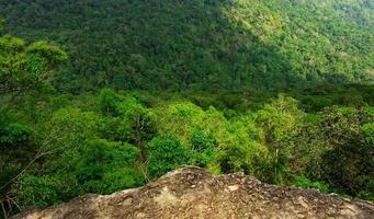 Beautiful view from peak of cliff at the mountain in tropical forest background . Ecosystem and healthy environment concept. photo