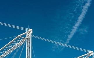 Closeup building crane against blue sky and clouds. photo