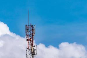 Telecommunication tower with blue sky and white clouds. Worker installed 5g equipment on telecommunication tower.Communication technology. Telecommunication industry. Mobile or telecom 5g network. photo