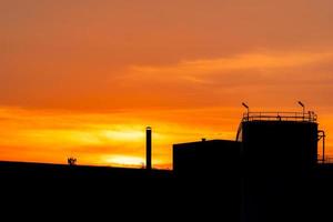 Gas turbine electrical power plant. Energy for support factory in industrial estate. Natural gas tank. Small gas power plant. Power plant using natural gas for fuel. Green energy. Dramatic sunset sky. photo