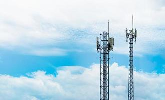 Telecommunication tower with blue sky and white clouds. Antenna on blue sky. Radio and satellite pole. Communication technology. Telecommunication industry. Mobile or telecom 4g network. Technology photo