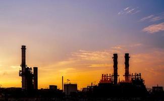 Gas turbine electrical power plant. Energy for support factory in industrial estate. Natural gas tank. Small gas power plant. Power plant using natural gas for fuel. Green energy. Dramatic sunset sky. photo