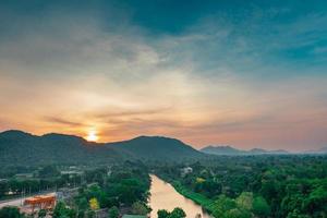 Beautiful nature landscape of mountain range with sunrise sky and clouds. City in mountain valley in Thailand. Scenery of mountain layer with morning sunrise. Tropical forest. Nature background. photo