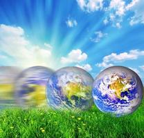 Earth globe rolling on green grass photo