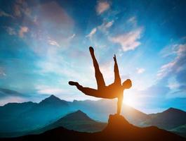 Man jumping over rocks in parkour action in mountains. photo