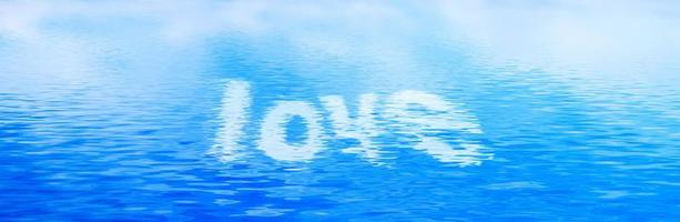 Love text in clean water waves. Banner, panorama. photo