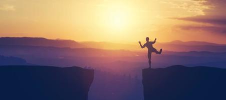 Man balancing on the edge of a cliff. photo