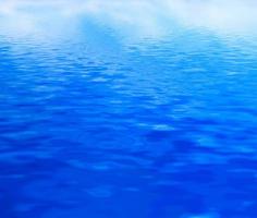 Clean water background, calm waves. Blue reflection photo
