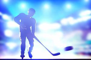 Hockey player shooting on goal in arena night lights photo