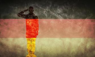 German grunge flag with soldier silhouette. photo