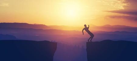 Man trying to keep balance on the cliff. photo