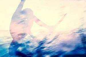 Double exposure of a surfer surfing in the ocean. photo