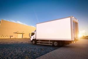 Commercial delivery truck with blank white trailer on cargo parking. photo