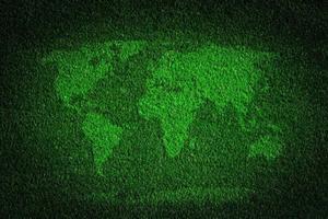 World map on green grass field background photo