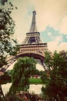 Eiffel Tower from Champ de Mars park in Paris, France. Vintage photo