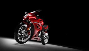 Front view of red sports motorcycle in a spotlight