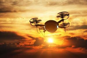 Drone flying at sunset. Sun shining on dramatic sky. photo