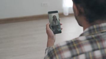 A man with mental health problems is consulting a doctor online via mobile phone. Online medical services reduce risks from social distances. The concept of online treatment video