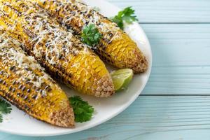 barbecue and grilled corn with cheese and lime photo