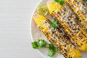 barbecue and grilled corn with cheese and lime photo