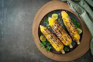 barbecue and grilled corn with cheese and lime photo