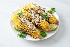 barbecue and grilled corn with cheese and lime photo