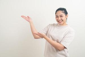 Asian woman with hand presenting on wall photo