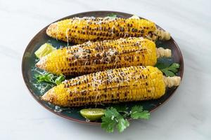 barbecue and grilled corn with cheese and lime photo