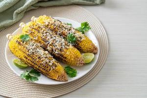 barbecue and grilled corn with cheese and lime photo