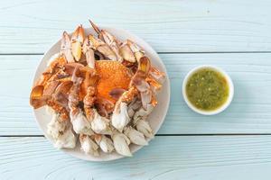 Steamed blue crab with spicy seafood sauce photo