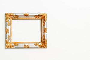 empty picture frame on white wall background photo