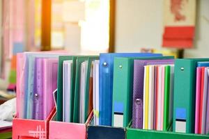 Closeup view of paperwork box for keeping various documents inside which is placed on the table in the office, soft focus. photo