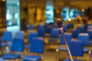 Microphone over business people forum Meeting, microphone in meeting room on table with selective focus, Close-up mic for speaker speech presentation backgrounds, Conference Training Concept photo