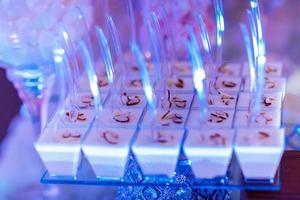 Candy bar on wedding ceremony with a lot of different cupcakes, modern desserts, mousses and jellies. selective focus photo