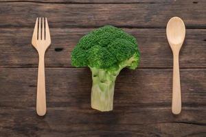 Broccoli vegetable on wood has spoon and fork healthy eating clean food concept. photo