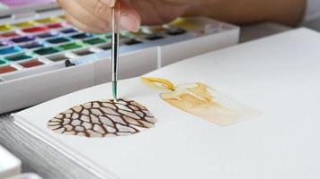 Lady is drawing pinecone using watercolor - people with Christmas celebration art hand draw watercolor concept video