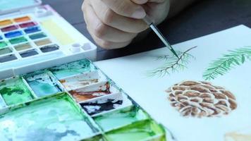 Lady is drawing pinecone using watercolor - people with Christmas celebration art hand draw watercolor concept