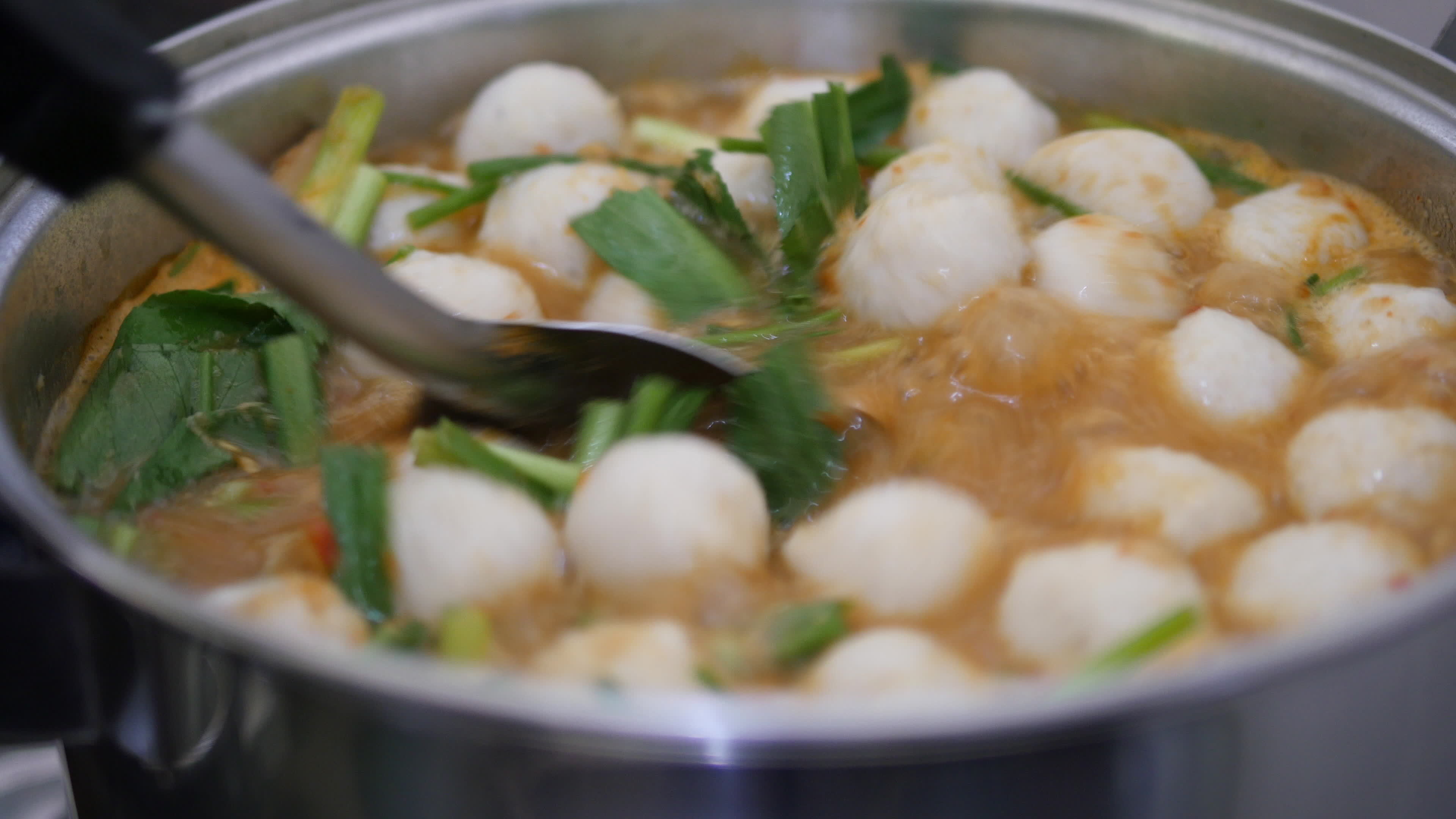 Closeup of preparing or cooking traditional Thai food in kitchen - Thai