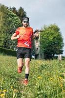 Runner in training on a meadow trail photo