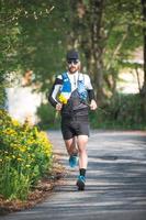 Athlete running with yellow flowers in hand photo