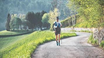 Man practices Nordic walking over long distances photo