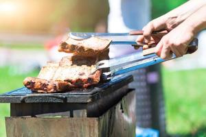 Preparation of grilled meat on barbecue photo