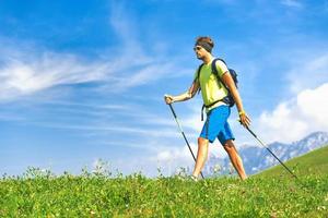 Nordic walking activities with sticks in nature in the hills photo
