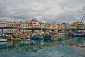 View of Genoa in Italy with palaces streets and boats photo