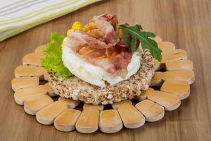 Crispy sandwich with egg and bacon photo