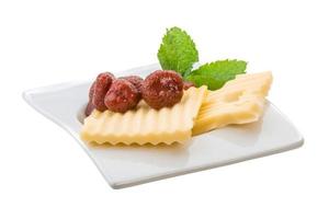 Slice of cheese with strawberry and mint photo