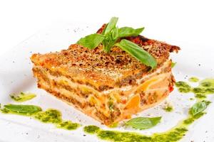 Closeup of lasagna and basil fork photo