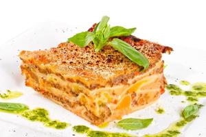 Closeup of lasagna and basil fork photo