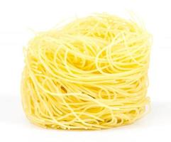 A portion of tagliatelle italian pasta isolated on white photo