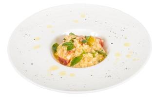 photo of delicious risotto dish with herbs and tomato on white background